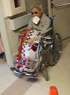Old lady wheelchair eating paper